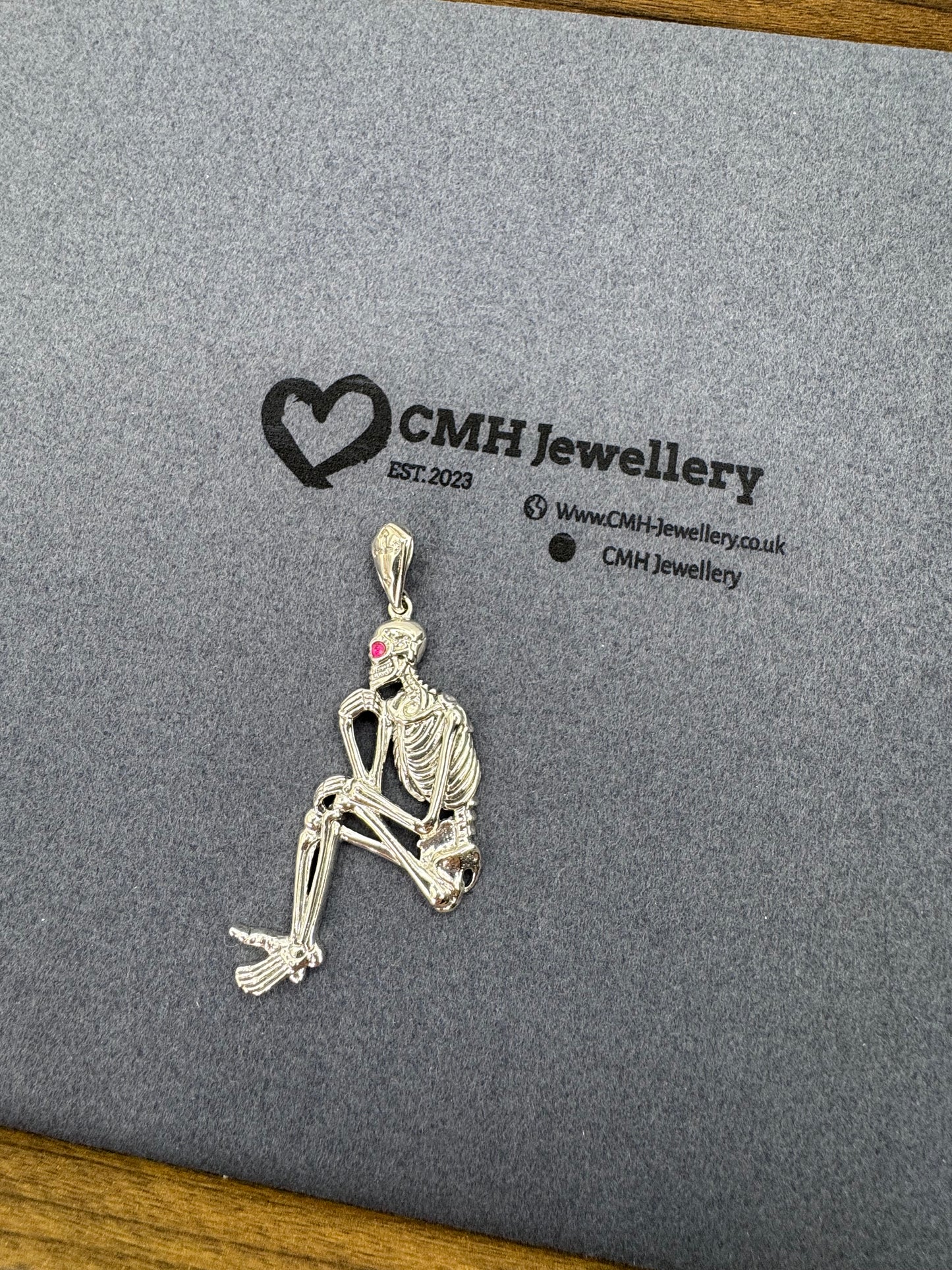 Sterling Silver Sitting Skeleton Pendant w/Ruby Eye